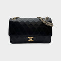 CHANEL shoulder bag features a Matelasse design, a turnlock pattern, a Coco mark, black chain shoulder bag, gold hardware, and leather.