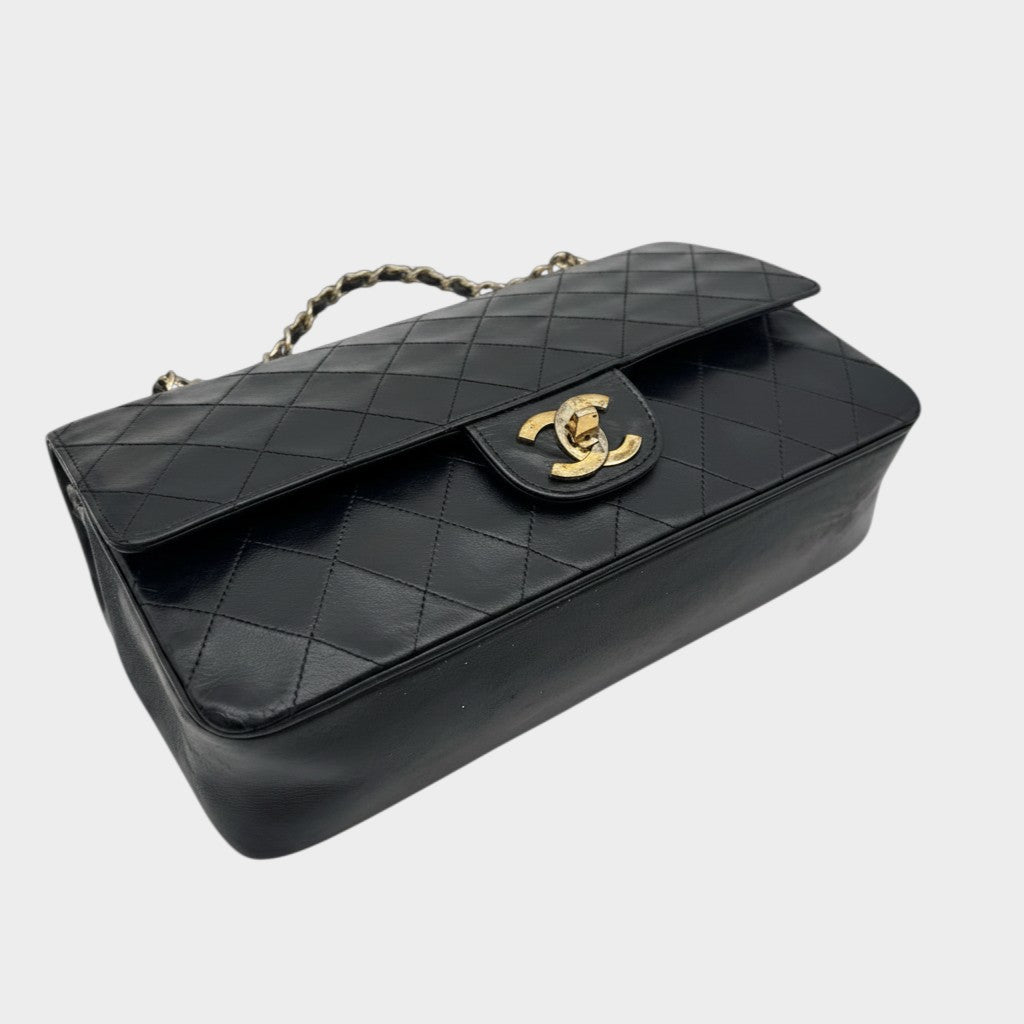 CHANEL shoulder bag features a Matelasse design, a turnlock pattern, a Coco mark, black chain shoulder bag, gold hardware, and leather.