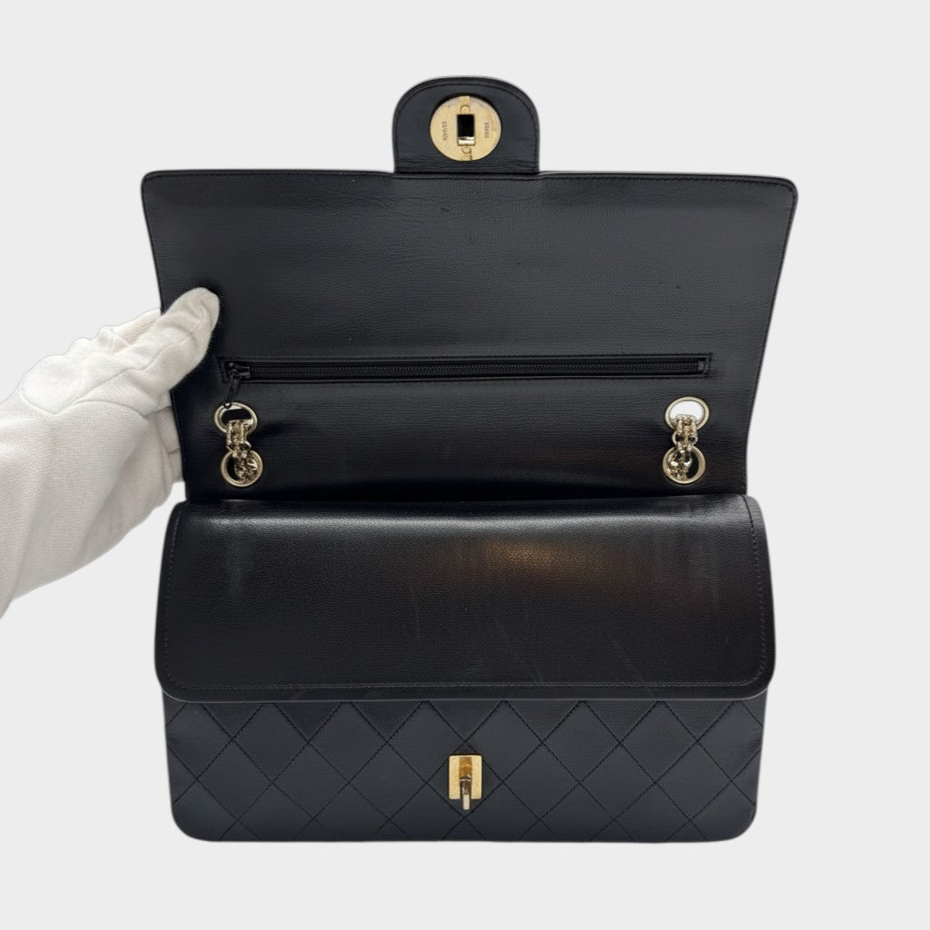 CHANEL shoulder bag features a Matelasse design, a turnlock pattern, a Coco mark, black chain shoulder bag, gold hardware, and leather.