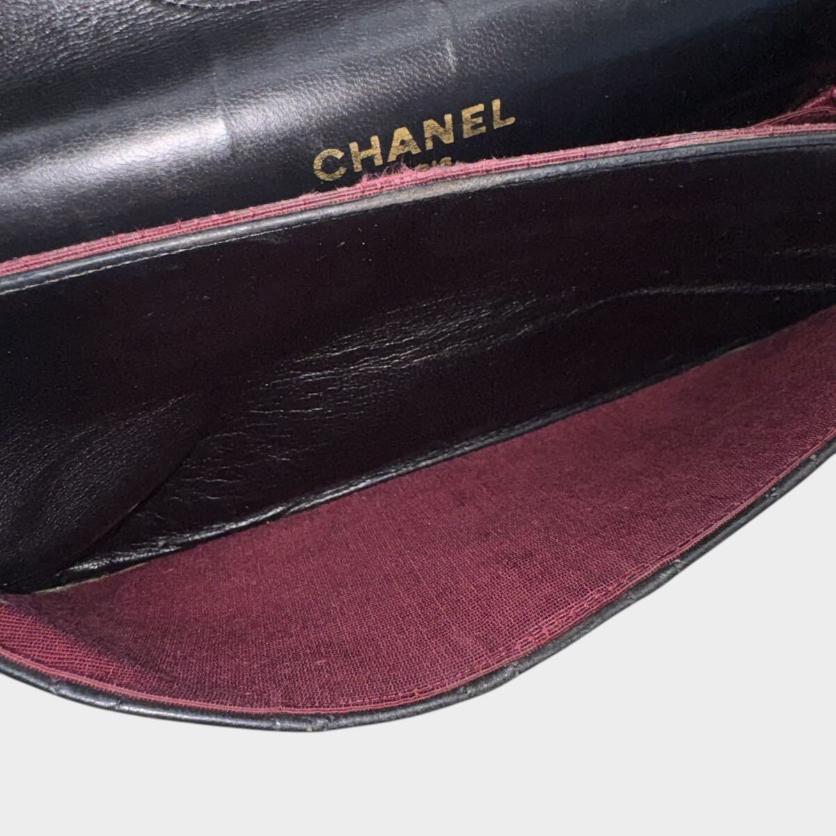 CHANEL shoulder bag features a Matelasse design, a turnlock pattern, a Coco mark, black chain shoulder bag, gold hardware, and leather.