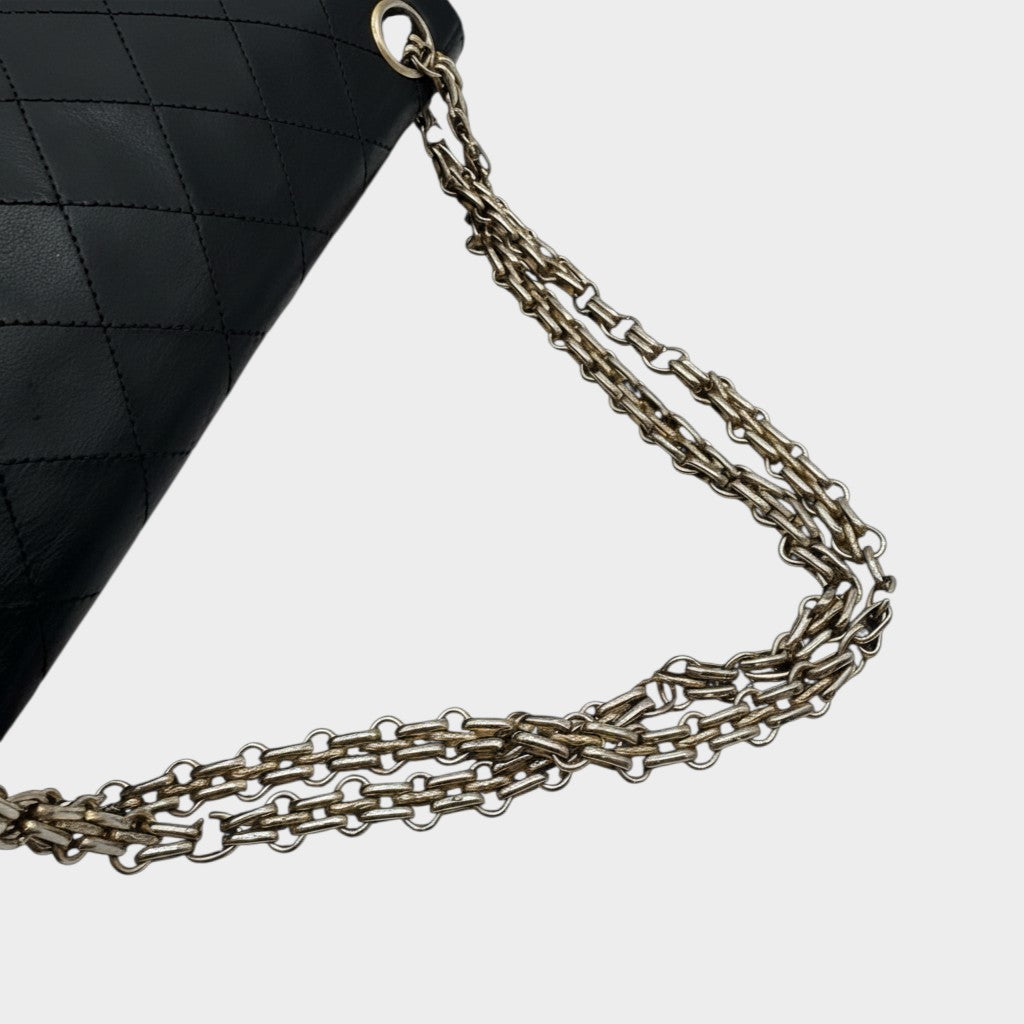 CHANEL shoulder bag features a Matelasse design, a turnlock pattern, a Coco mark, black chain shoulder bag, gold hardware, and leather.